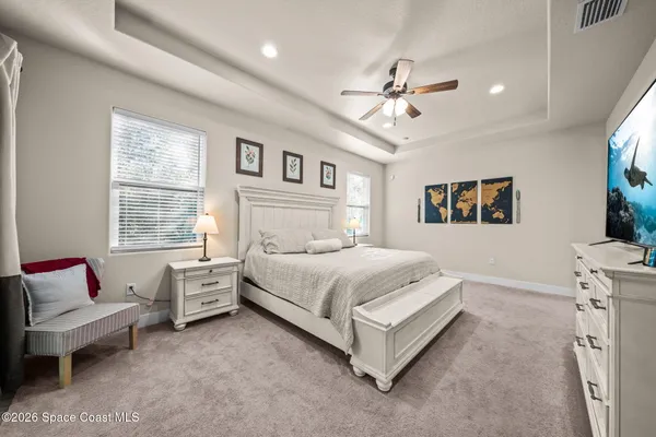 a bedroom with a bed couch and window