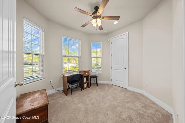 a bedroom with a bed and ceiling fan