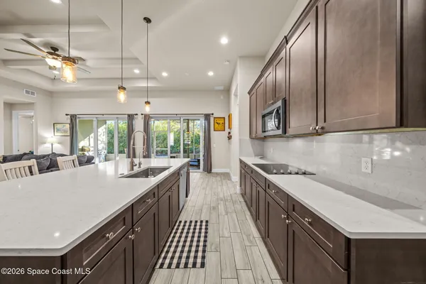 a kitchen with stainless steel appliances a sink stove and cabinets