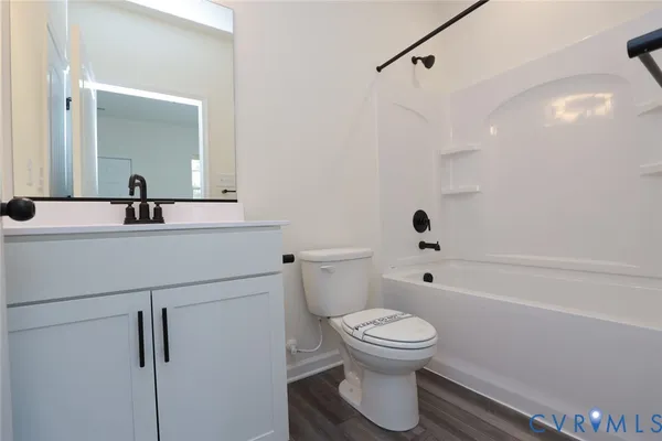 a bathroom with a toilet sink a mirror and shower