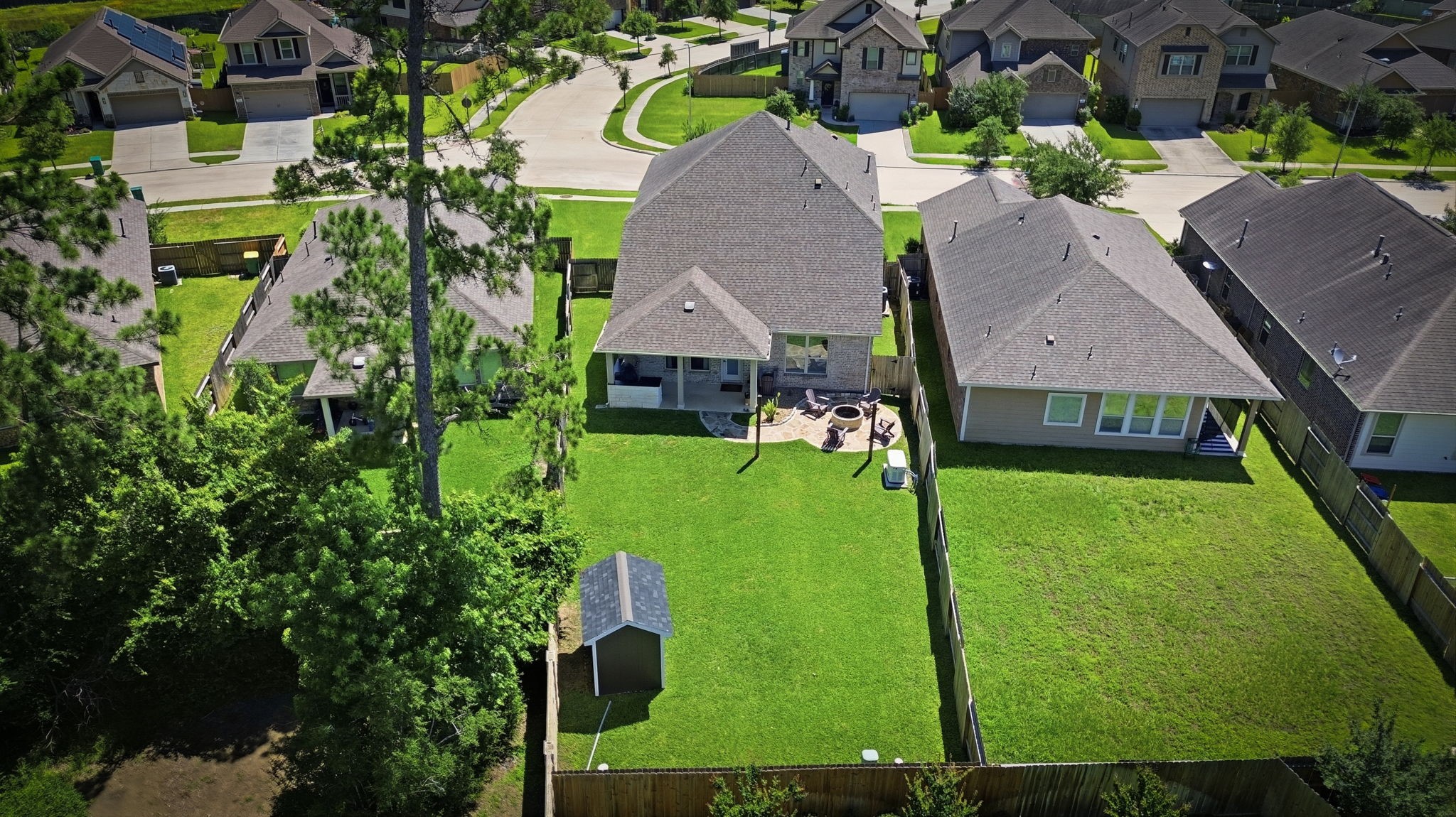 4334 Umber Shadow Drive Spring, TX 77386 - Photo 41 of 45 Aerial backyard view highlights the expansive lawn, covered patio, and fully fenced outdoor space.