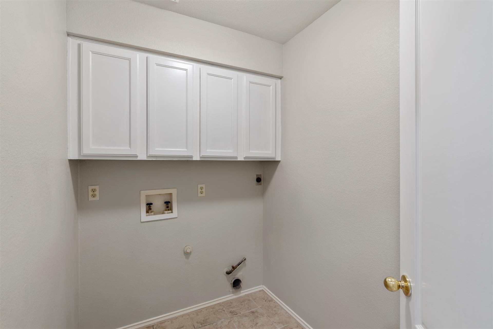 4725 Tello Path Austin, TX 78749 - Photo 30 of 34 Ample cabinetry and utility connections offer a functional space for laundry tasks.