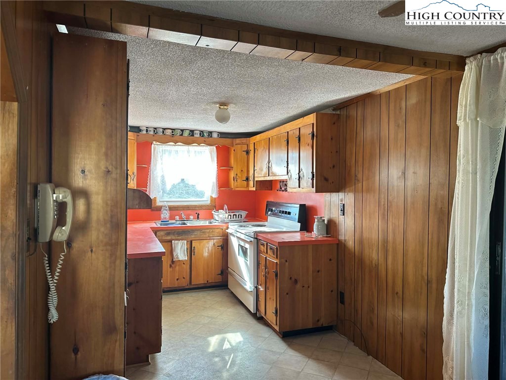 1620 Little Pine Road Ennice, NC 28623 - Photo 7 of 15 a kitchen with stainless steel appliances a stove and a refrigerator