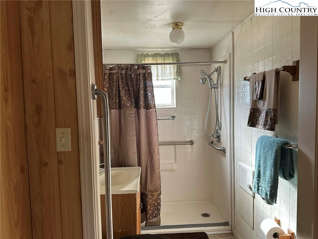 1620 Little Pine Road Ennice, NC 28623 - Photo 8 of 15 a bathroom with a shower and a glass door