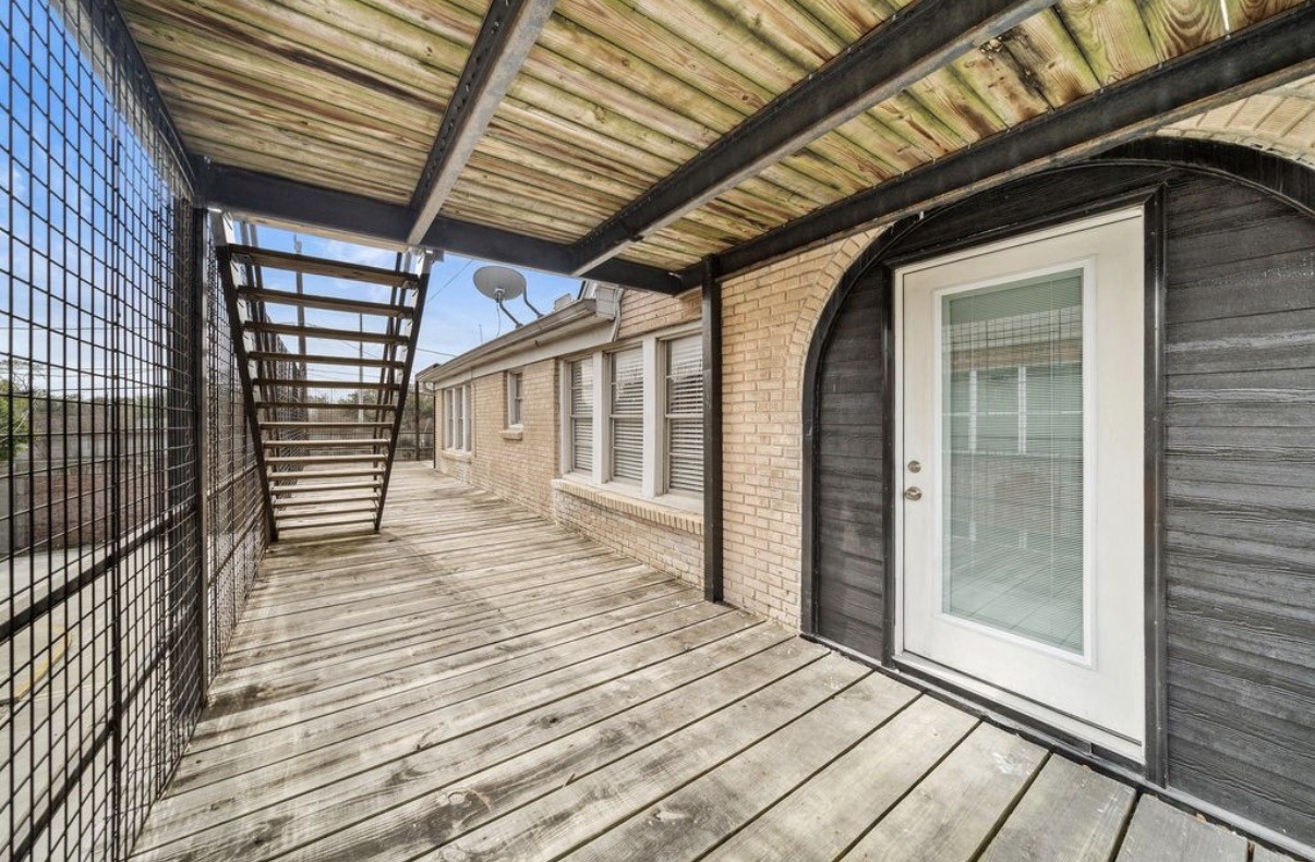 1633 Castle Court Houston, TX 77006 - Photo 19 of 38 Spacious upstairs deck with private entry, offering a covered outdoor area perfect for relaxing or enjoying fresh air. Features sturdy wood flooring, overhead shade, and secure railing—an ideal extension of the living space with plenty of natural light.