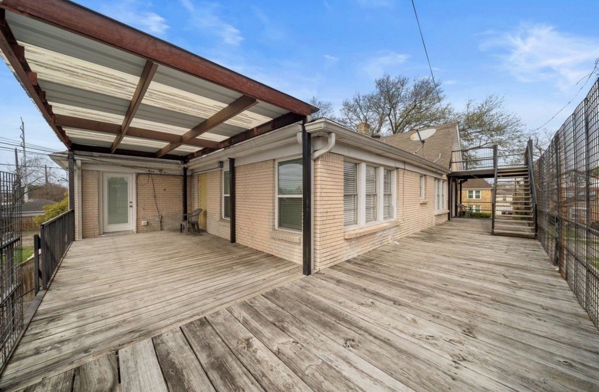 1633 Castle Court Houston, TX 77006 - Photo 21 of 38 Expansive upper-level deck offering plenty of outdoor living space, perfect for lounging, entertaining, or enjoying fresh air. The covered section adds shade and year-round usability, while the open areas provide great natural light. A versatile extension of the home with room for seating, plants, and outdoor dining.