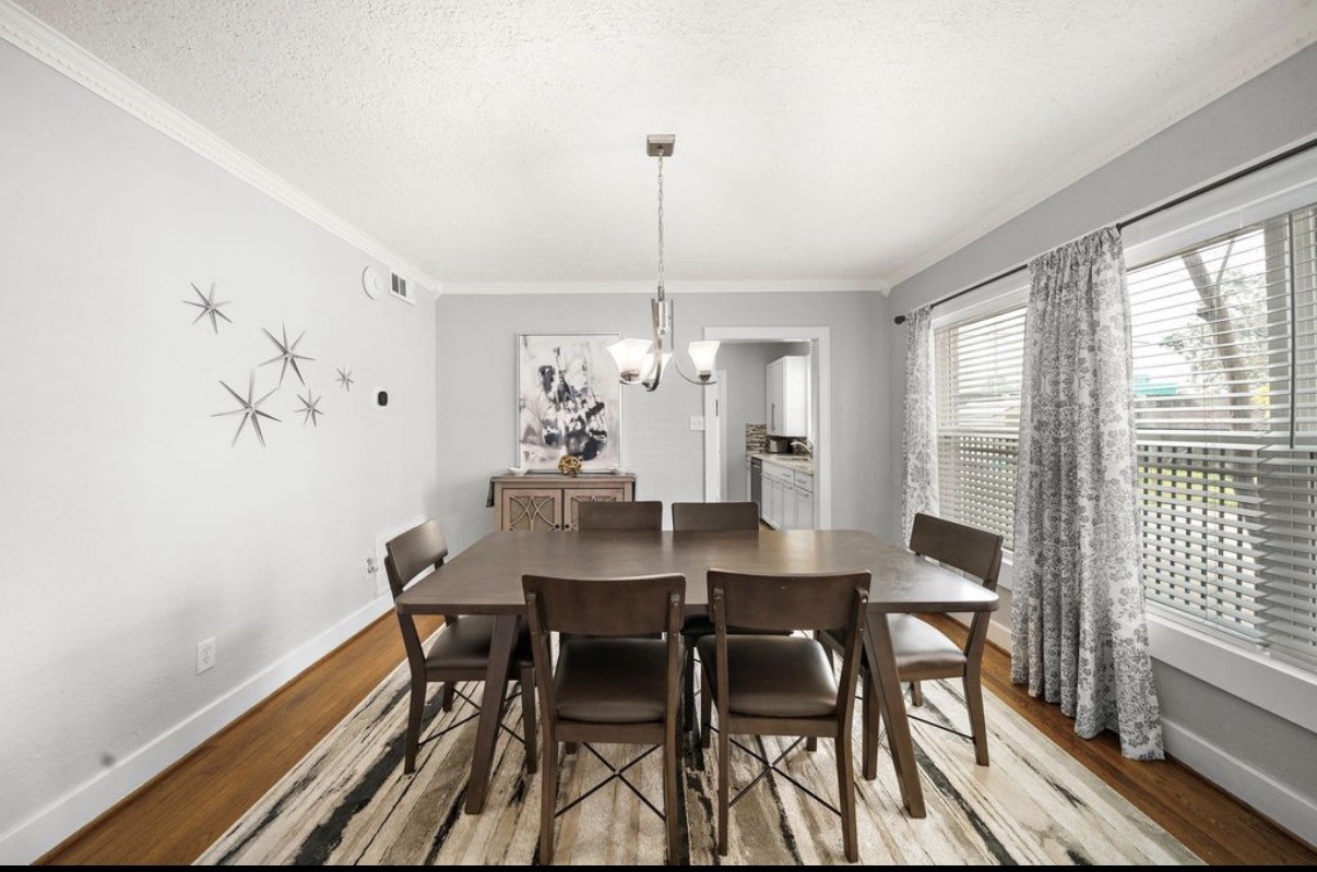 1633 Castle Court Houston, TX 77006 - Photo 7 of 38 Beautifully staged dining room showcasing abundant natural light, elegant clean lines, and a spacious layout perfect for gatherings.