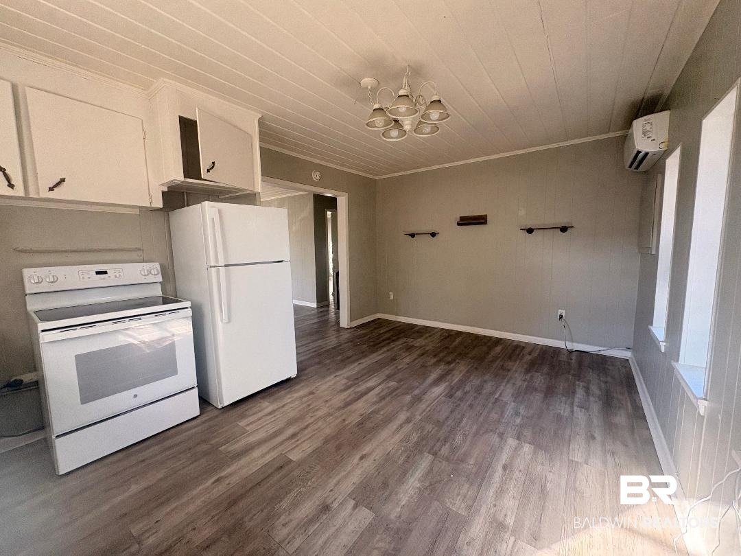9330 Pinewood Avenue, Unit S 1 2 3 4 Elberta, AL 36530 - Photo 7 of 12 Kitchen featuring suspended lighting, white appliances, dark wood-type flooring, and wooden ceiling