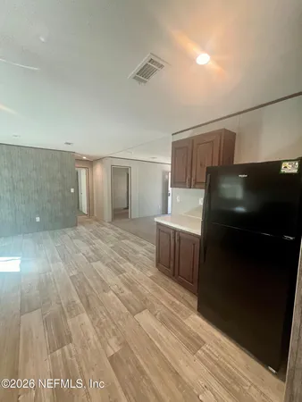 a view of a kitchen from the hallway