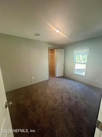 a view of an empty room and a window