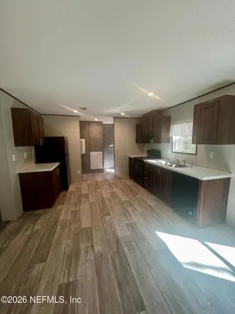a view of kitchen with wooden floor