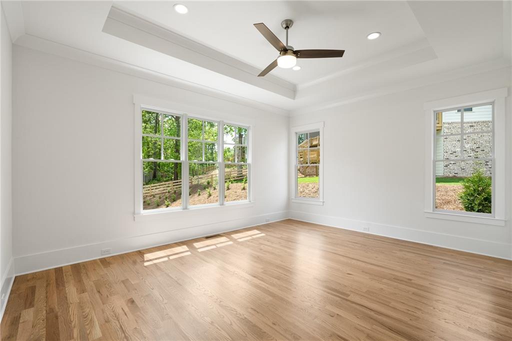 326 Reese Way Ball Ground, GA 30107 - Photo 12 of 37 a view of an empty room with wooden floor and a window