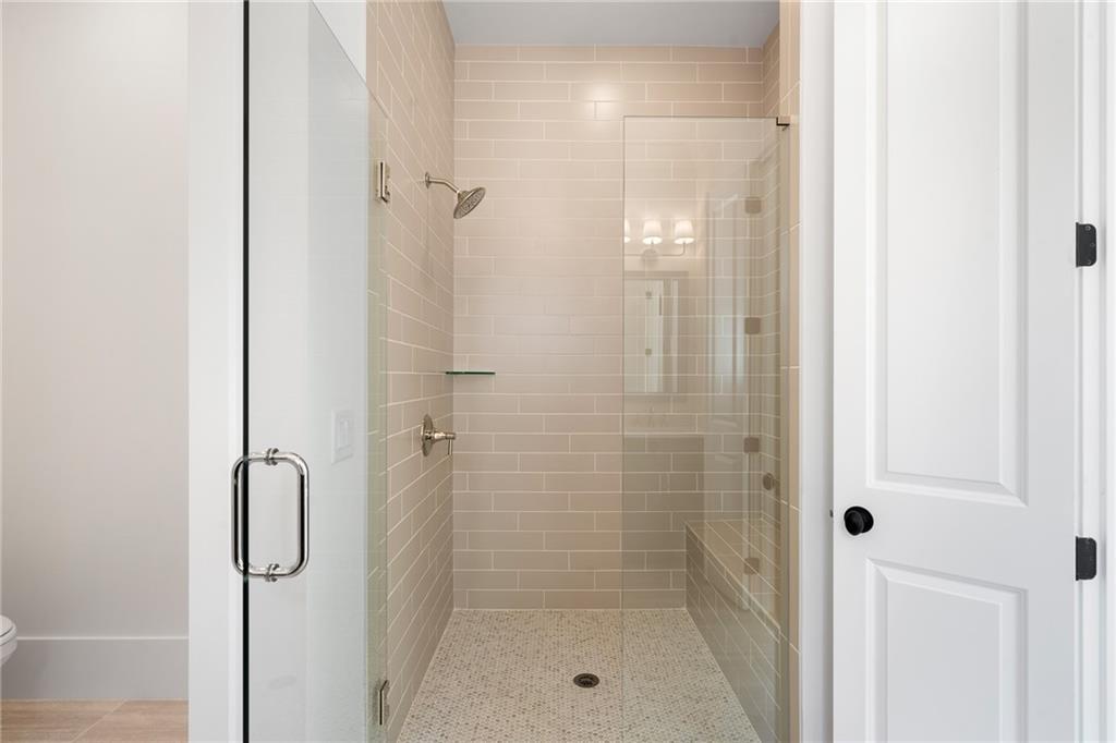 326 Reese Way Ball Ground, GA 30107 - Photo 15 of 37 a bathroom with a glass shower door