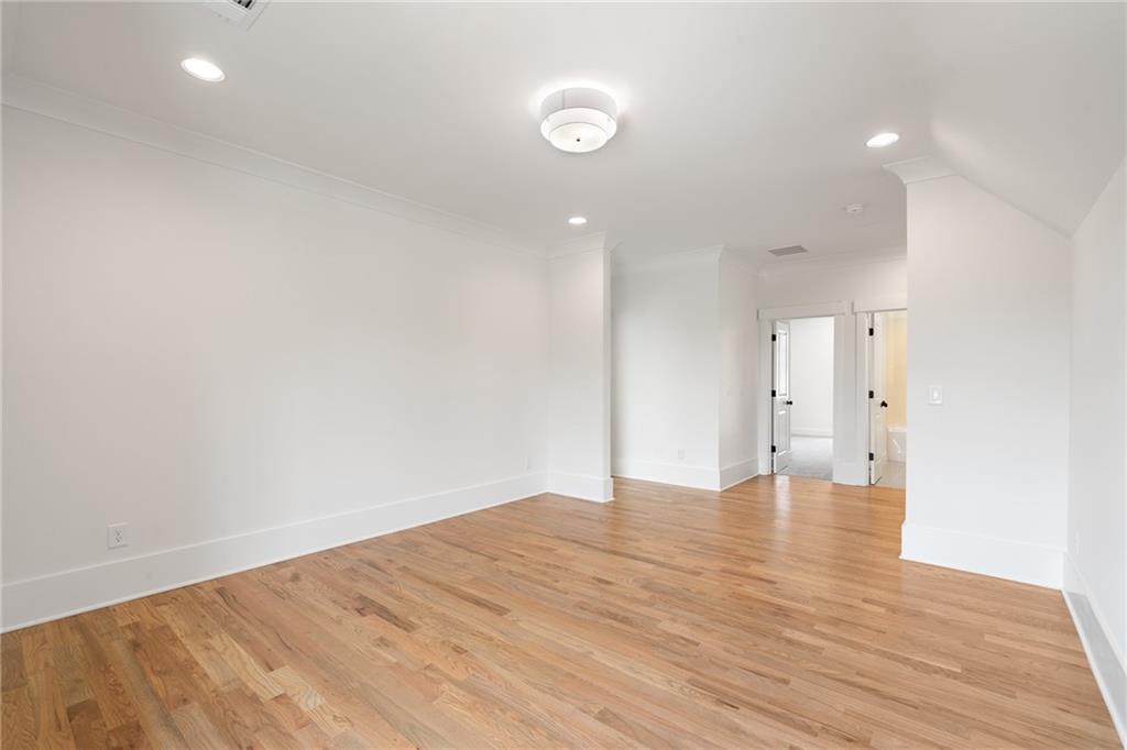 326 Reese Way Ball Ground, GA 30107 - Photo 21 of 37 a view of an empty room with wooden floor and a window