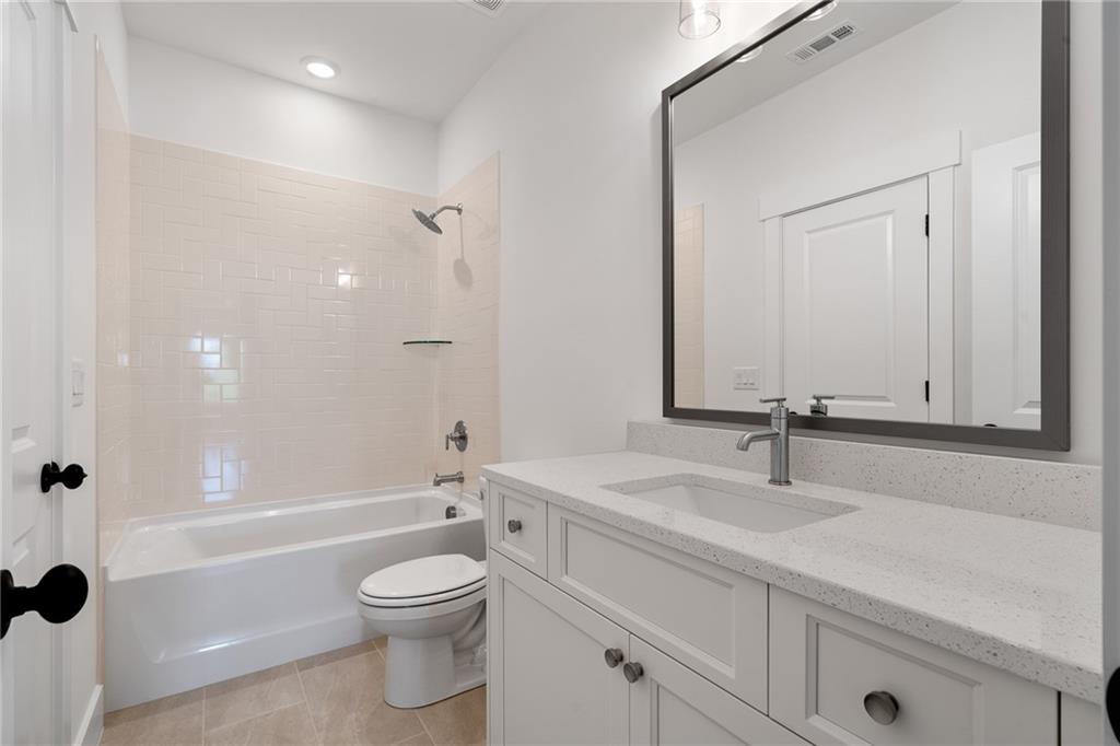326 Reese Way Ball Ground, GA 30107 - Photo 24 of 37 a bathroom with a sink a toilet and shower