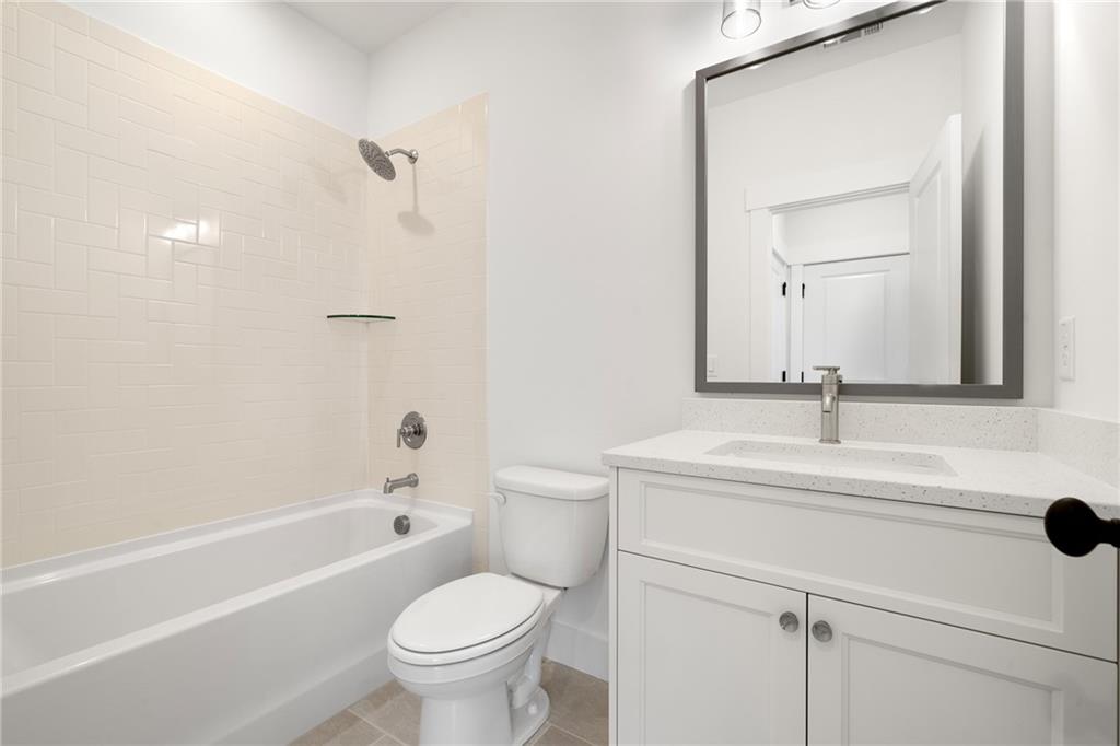 326 Reese Way Ball Ground, GA 30107 - Photo 26 of 37 a bathroom with a sink a toilet and a mirror