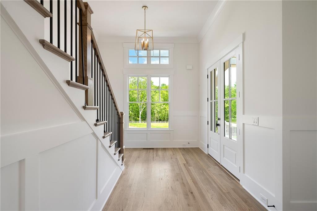 326 Reese Way Ball Ground, GA 30107 - Photo 3 of 37 a view of an entryway with wooden floor and stairs
