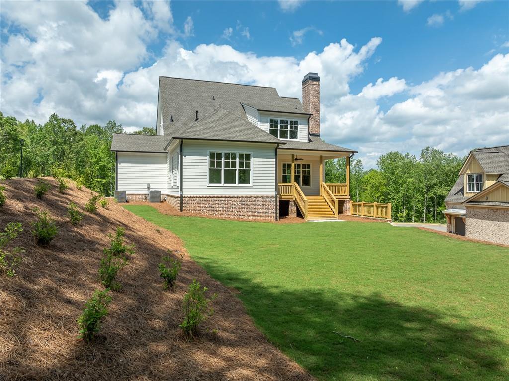 326 Reese Way Ball Ground, GA 30107 - Photo 34 of 37 a front view of a house with a garden