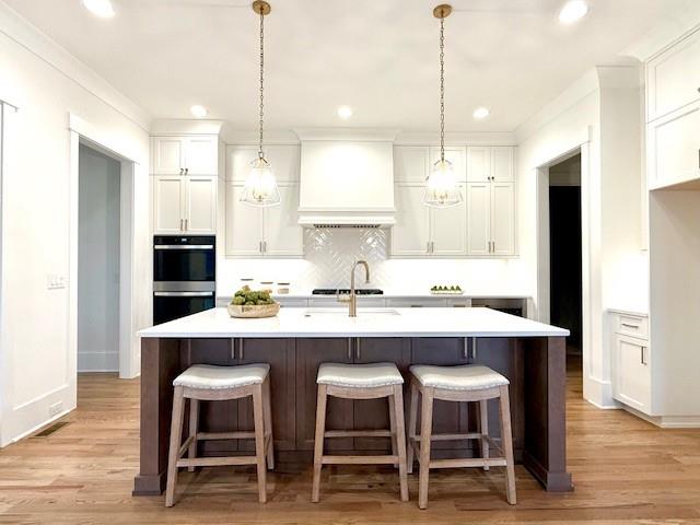 326 Reese Way Ball Ground, GA 30107 - Photo 9 of 37 a kitchen with kitchen island granite countertop a sink a center island stainless steel appliances and cabinets