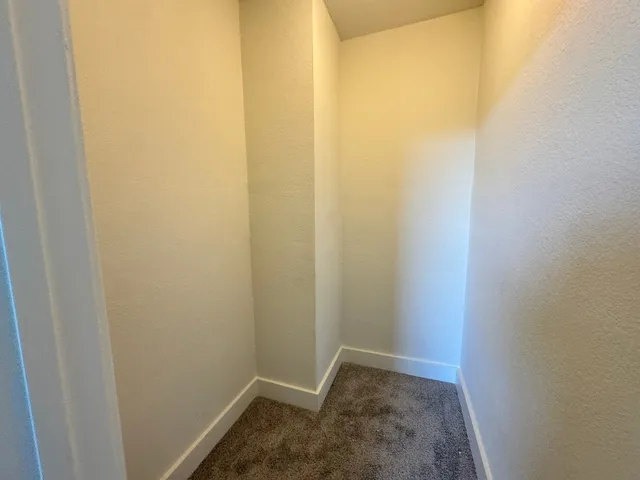an empty room with closet area