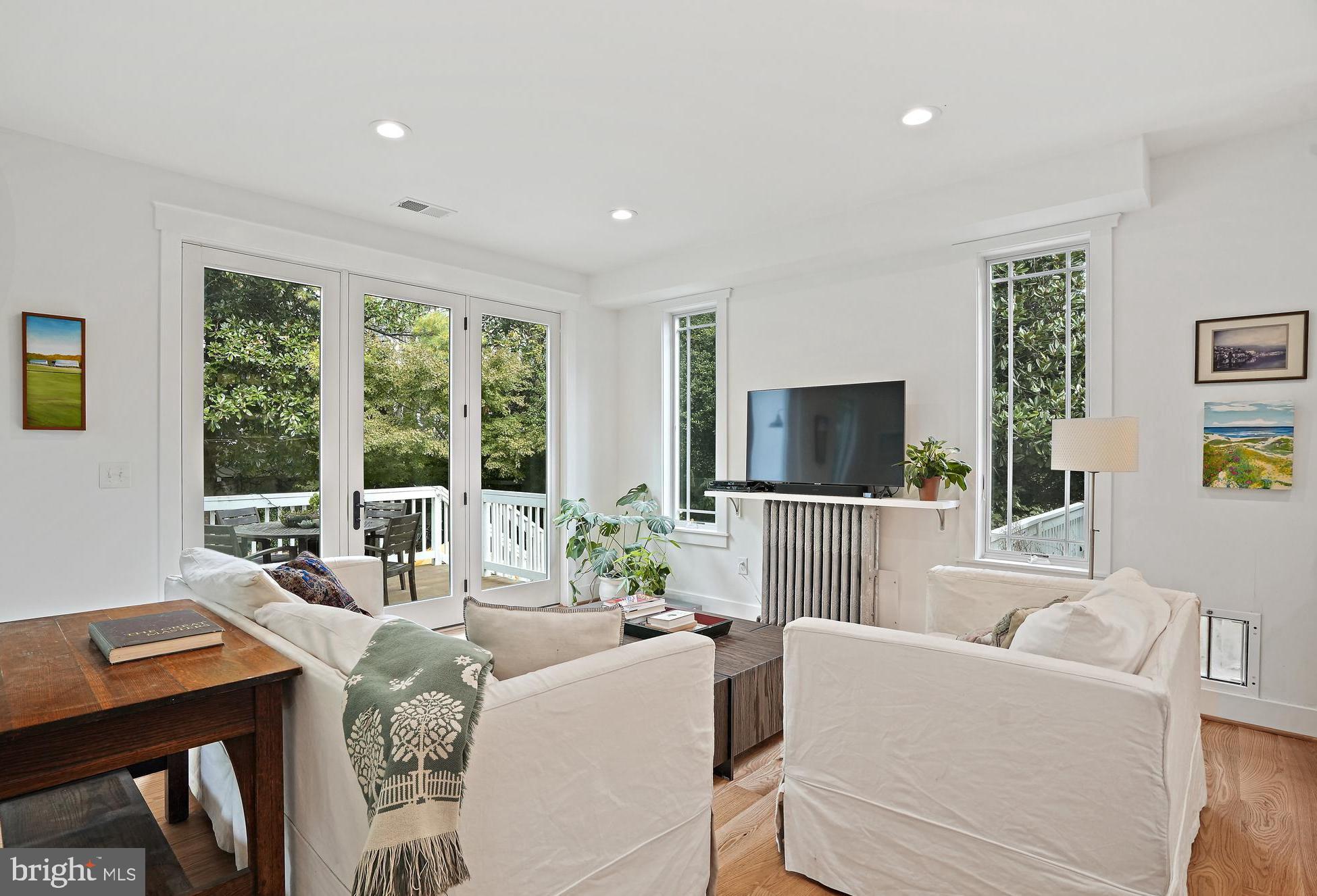 4621 Drummond Avenue Chevy Chase, MD 20815 - Photo 12 of 33 a living room with furniture a flat screen tv and a large window