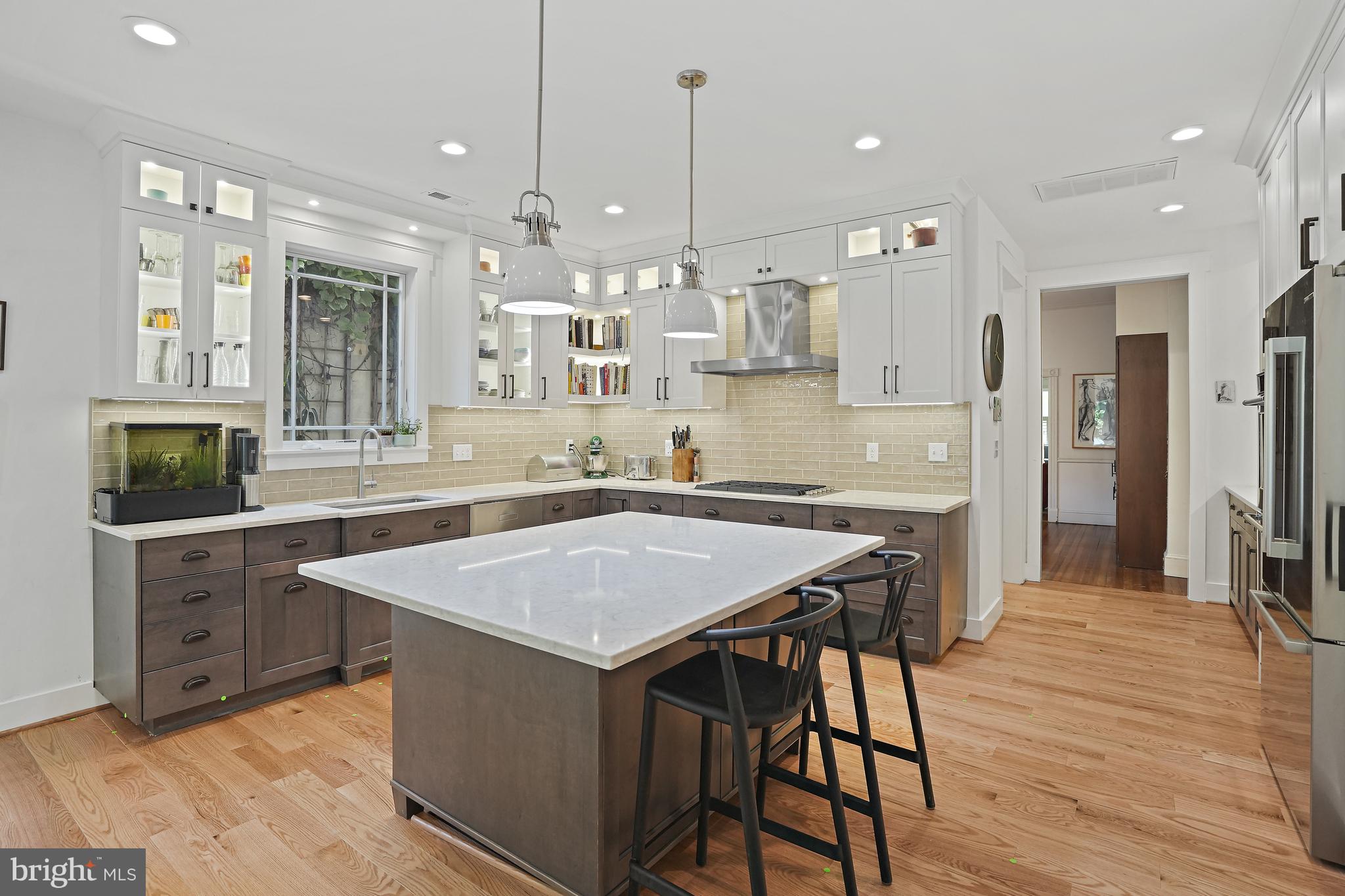 4621 Drummond Avenue Chevy Chase, MD 20815 - Photo 2 of 33 a kitchen with a table chairs refrigerator and microwave