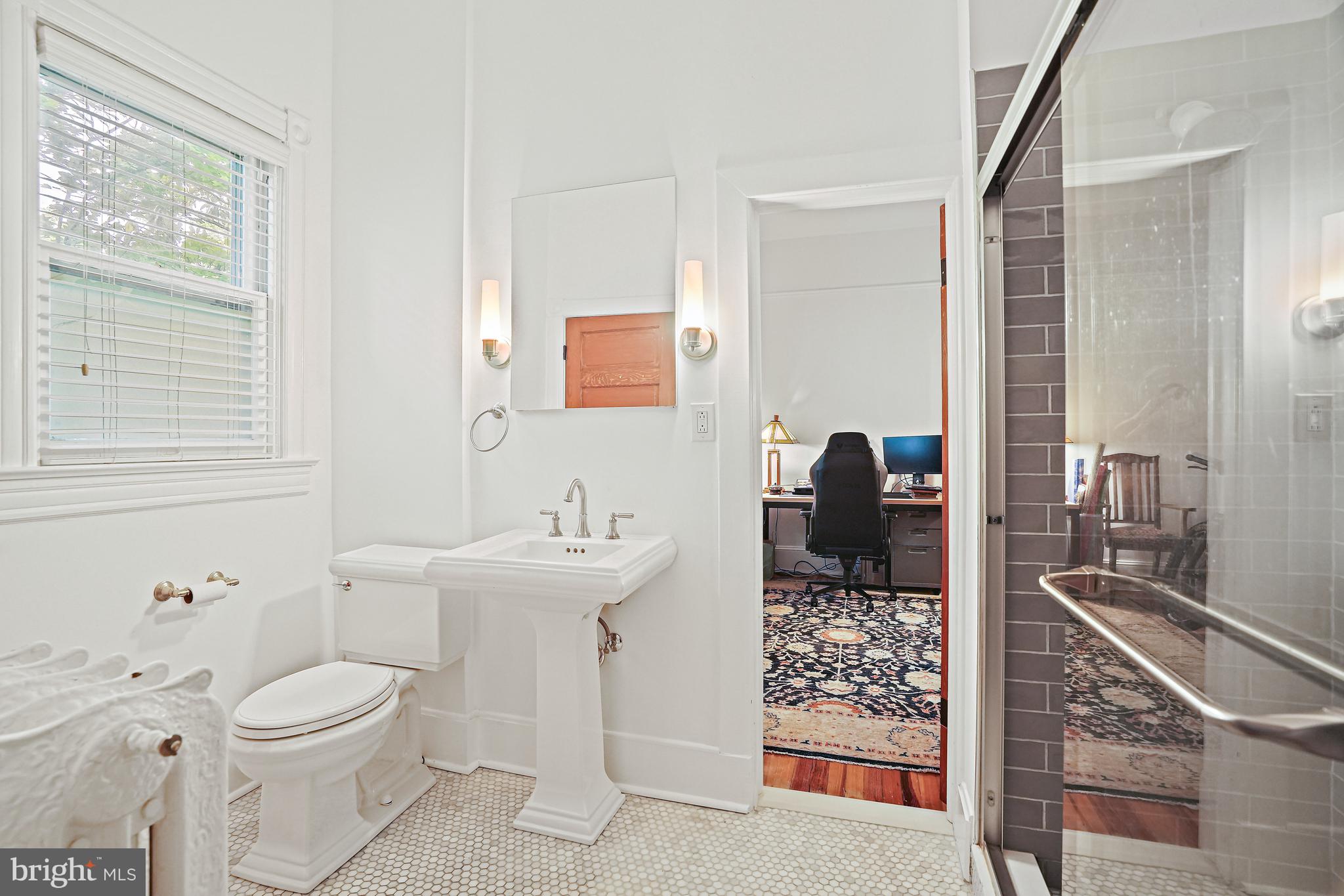 4621 Drummond Avenue Chevy Chase, MD 20815 - Photo 22 of 33 a bathroom with a toilet sink and mirror