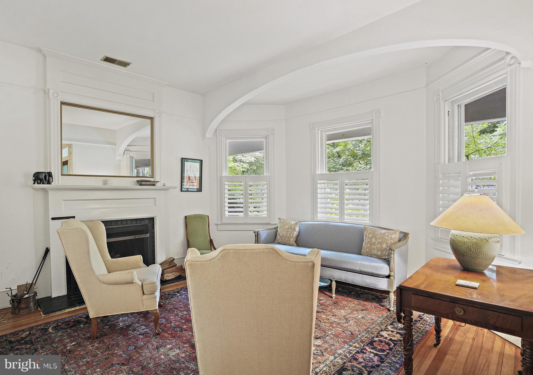 4621 Drummond Avenue Chevy Chase, MD 20815 - Photo 3 of 33 a living room with furniture a fireplace and a large window