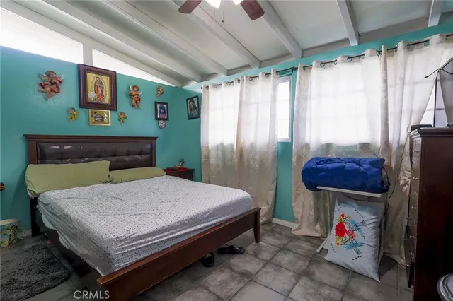 a bed sitting in a room next to a window