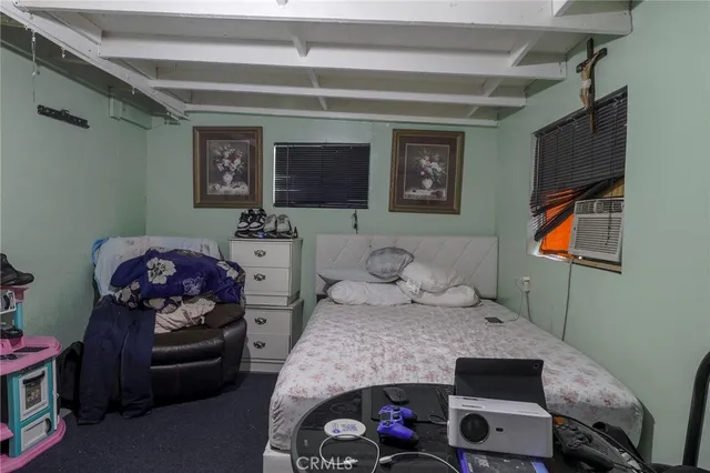 a bedroom with a bed and a window