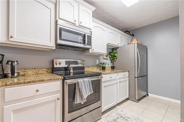 a kitchen with stainless steel appliances granite countertop a sink and cabinets