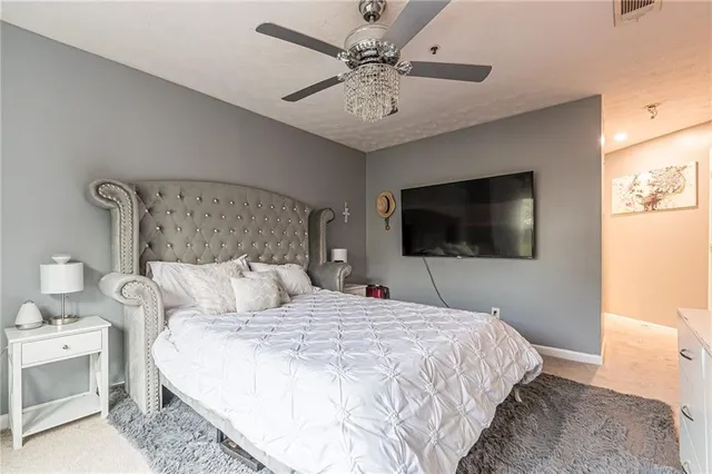 a bedroom with a bed and a chandelier