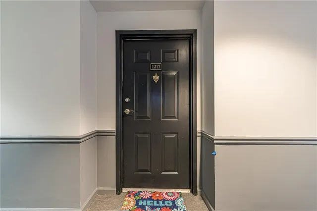 a view of bathroom with a sink a mirror and a potted plant