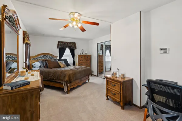 a bedroom with a bed and dresser
