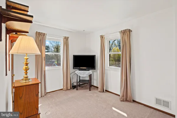 a view of a livingroom with workspace and a window