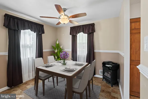 a view of a dining room with furniture and a chandelier