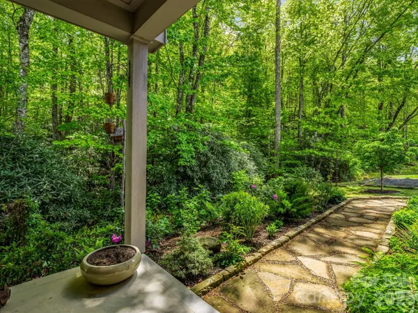 a view of a backyard with table and chairs potted plants