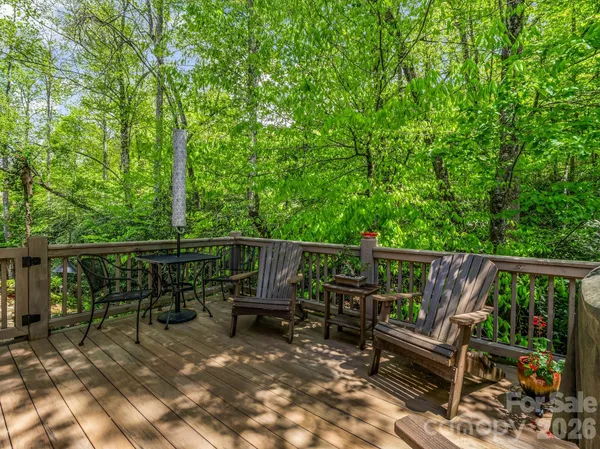 a view of deck with furniture and trees