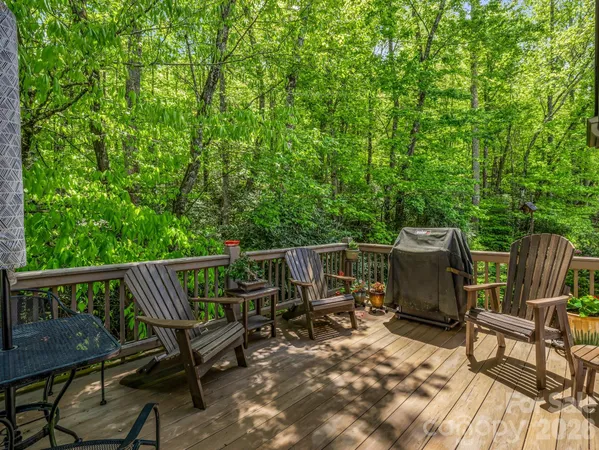 a view of backyard with seating and trees