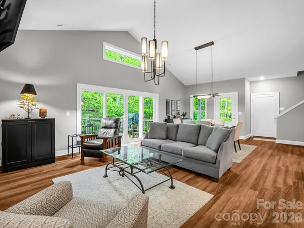 a living room with furniture and a chandelier