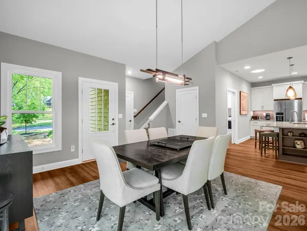 a dining room with furniture and wooden floor