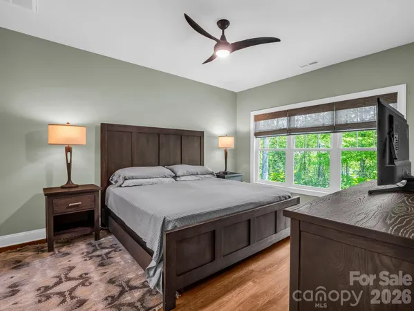 a bed sitting in a bedroom next to a window