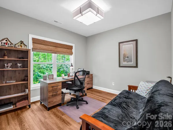 a living room with furniture a rug and a window