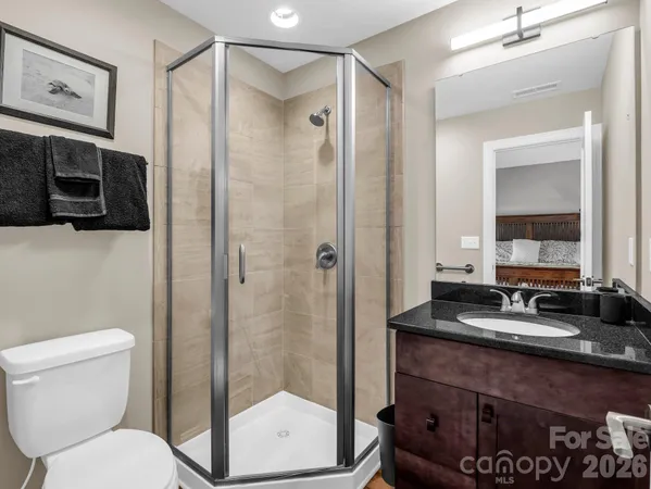 a bathroom with a toilet a sink and a mirror