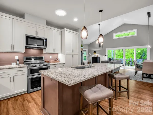 a kitchen with a table chairs and a stove