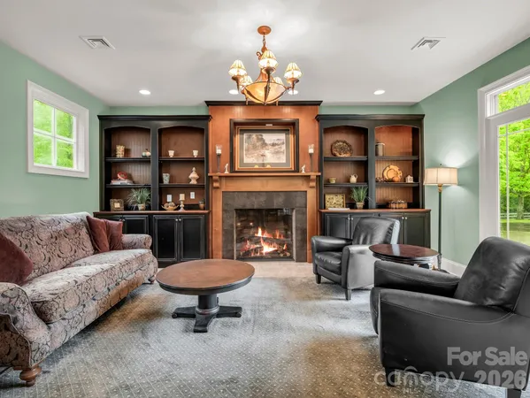a living room with furniture a window and a fireplace