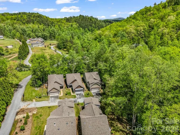 an aerial view of a house with garden space and street view