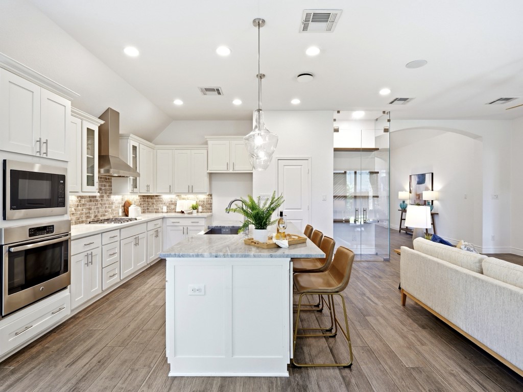 109 Lake Spring Circle Georgetown, TX 78633 - Photo 16 of 38 Culinary creativity awaits in this kitchen, boasting stainless steel appliances and an inviting island for casual dining.