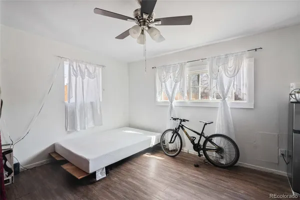 a view of a room with wooden floor and windows