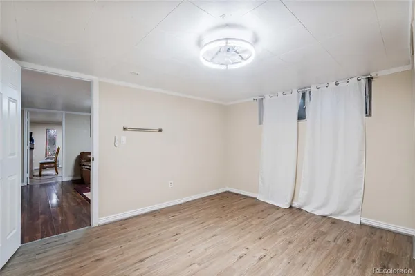 a view of a room with wooden floor